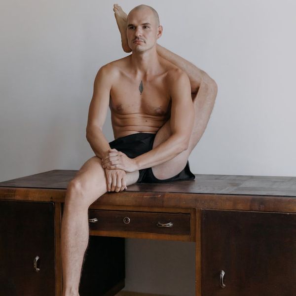 Man performing a controlled strength exercise in a minimalist environment.